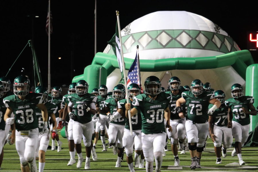 The Indians enter the field in their win over Mesquite Poteet.